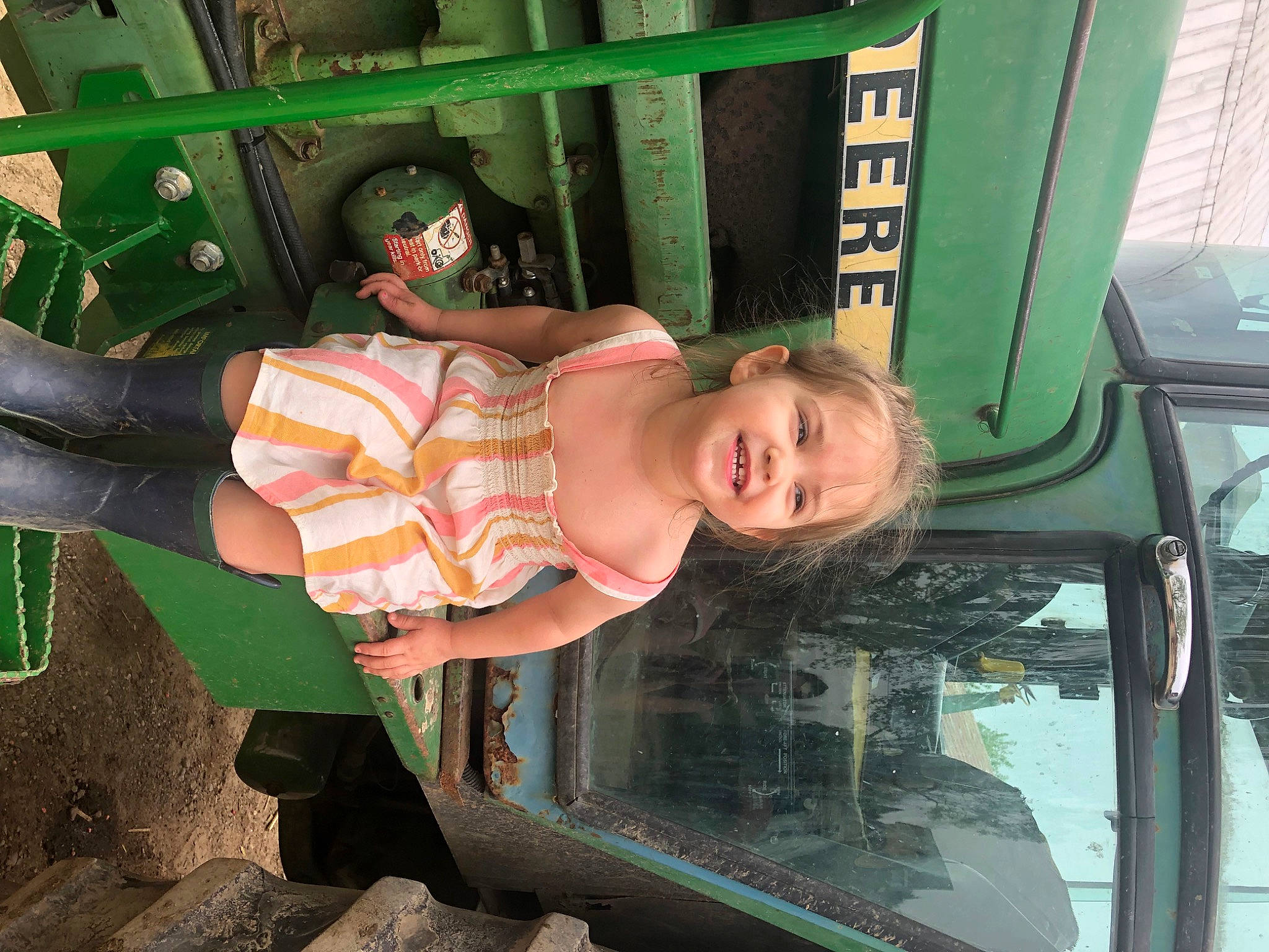 Annabelle is registered to the contest to win money with this photo: auto_part, automotive_exterior, automotive_wheel_system, baby_toddler_clothing, bumper, child, eyewear, fun, green, happy, hat, joy, leisure, motor_vehicle, person, smile, sunglasses, thigh, toddler, transport