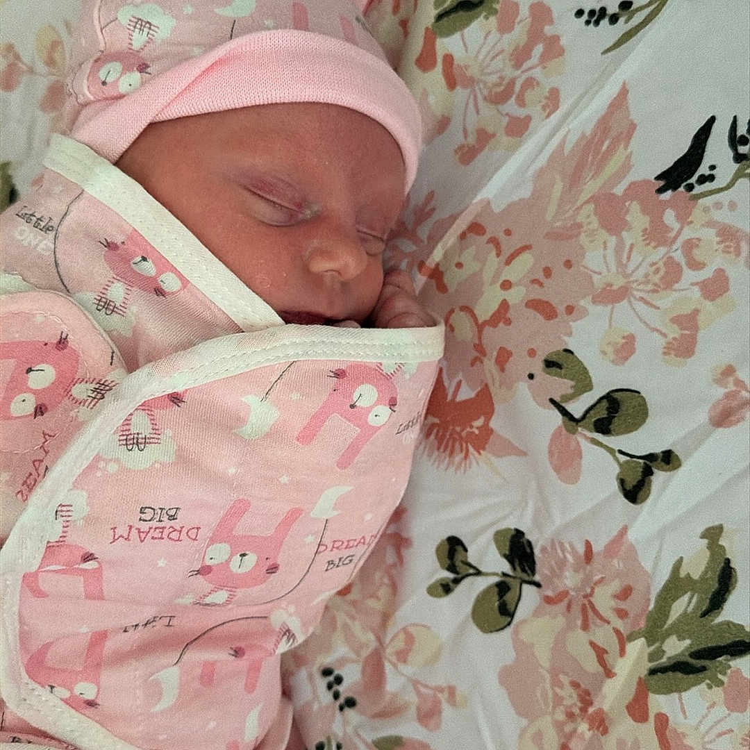 Addilyn joined the competition — help win amazing prizes! newborn, baby, sleeping, infant, portrait, pink, swaddled, blanket, hat, floral, bed, bedding, indoors, peaceful, cute, face, eyes_closed, textile, child, resting