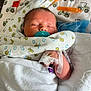Jase Jr is registered to the contest to win money with this photo: newborn, baby, blanket, pacifier, hospital, medical_tubes, bandage, sleeping, infant, swaddled, face, hand, closeup, healthcare, cute, child, person, bed, soft, rest