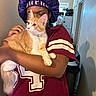 Sarabi joined the competition — help win amazing prizes! affection, box, casual_clothing, cat, close_up, curious_cat, domestic, feline, hallway, holding, home, indoor, kitchen, maroon_jersey, orange_cat, person, pet, purple_bonnet, trash_can, white_cat