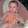 Mabel is registered to the contest to win money with this photo: baby, bathtub, bubbles, towel, rubber_duck, toy_car, water, child, indoor, bath_time, pink_bathtub, orange_towel, wet_hair, foam, skin, infant, cute, sitting, bath_toy, curious_expression