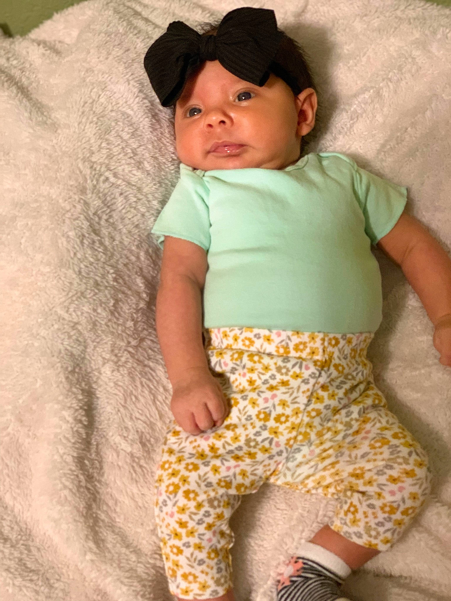Evelyn is registered to the contest to win money with this photo: abdomen, baby, baby_toddler_clothing, barefoot, baseball_cap, cap, child, comfort, happy, headwear, linens, pajamas, pattern, people, people_in_nature, person, sleeve, t_shirt, textile, thigh