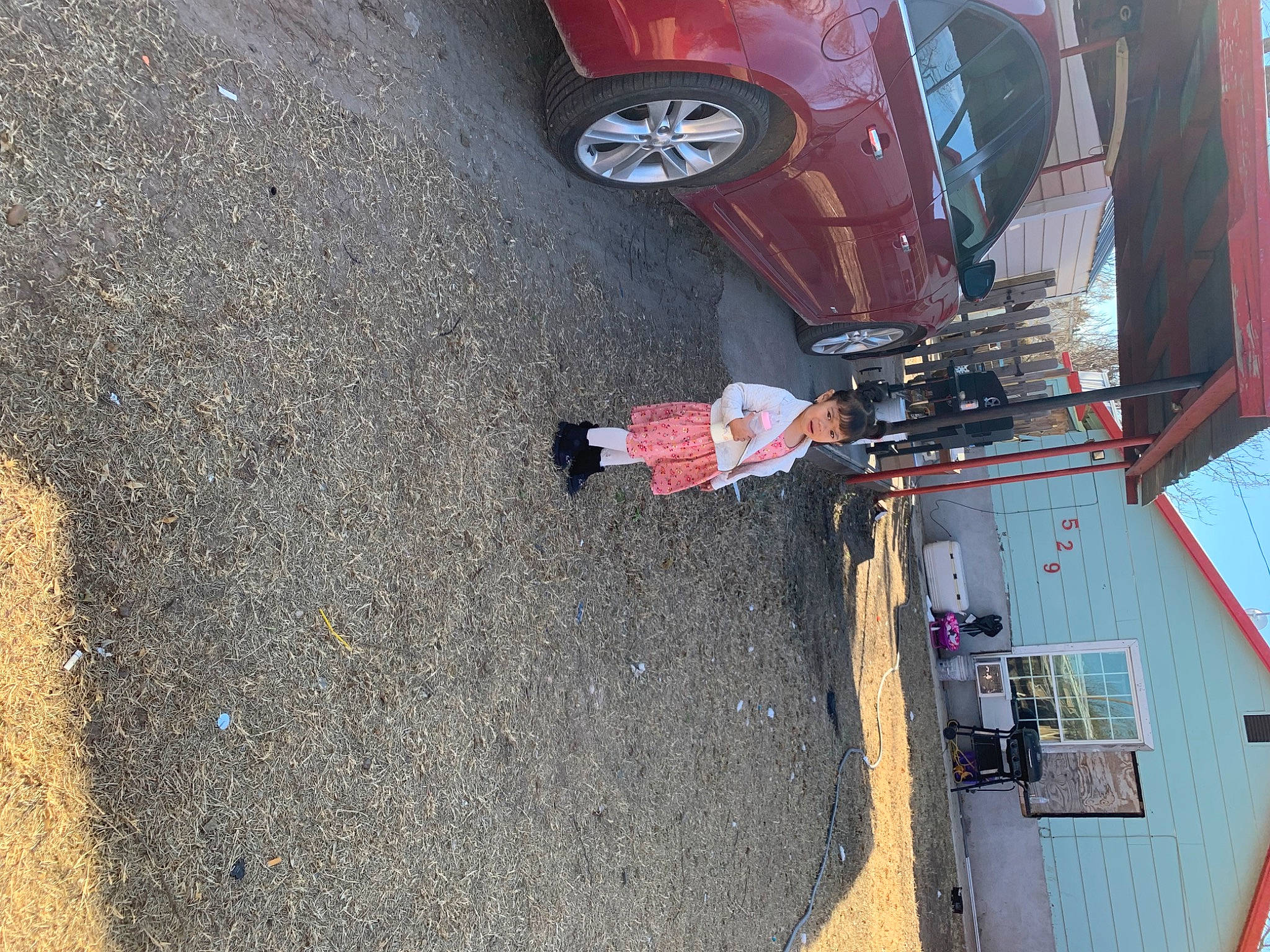 Daisy is registered to the contest to win money with this photo: asphalt, automotive_design, automotive_exterior, automotive_lighting, automotive_tail_brake_light, automotive_tire, bumper, car, fender, hood, leg, motor_vehicle, person, road_surface, synthetic_rubber, tints_and_shades, tire, tread, vehicle, wheel