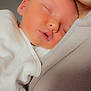 Ella joined the competition — help win amazing prizes! baby, sleeping, infant, person, closeup, smile, face, skin, fabric, clothing, comfort, nap, cozy, cuddle, human, head, child, soft, warm, rest