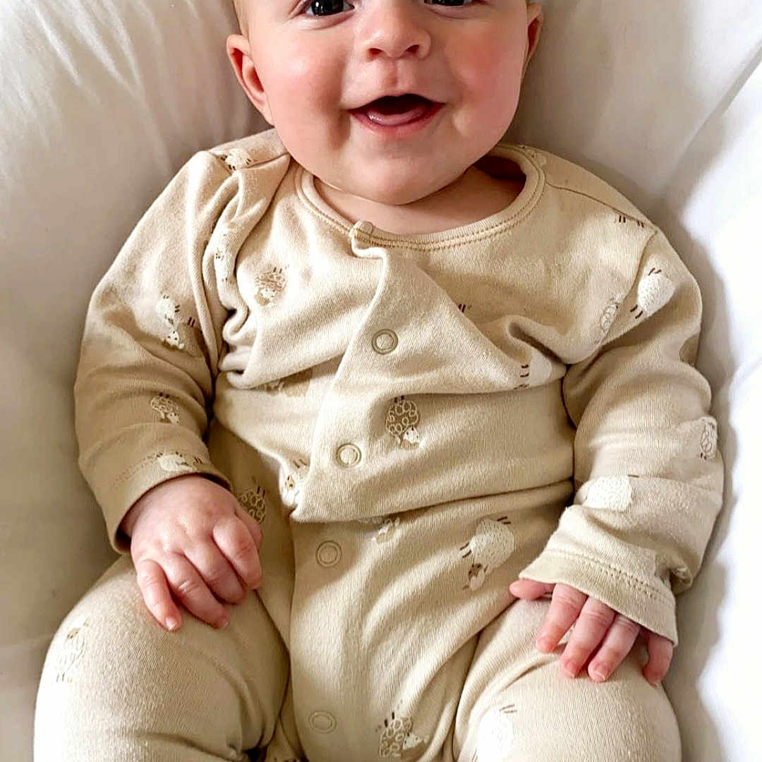 Leo joined the competition — help win amazing prizes! baby, babylaughing, blonde, bodypart, clothing, cushion, face, finger, hair, happy, head, homedecor, laughing, pajamas, pants, person, photography, portrait, sitting, smile