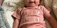 Kaelanie joined the competition — help win amazing prizes! baby, infant, smiling, pink_onesie, blanket, soft_texture, happy, lying_down, cute, portrait, child, skin, face, hand, legs, indoors, cozy, comfortable, clothing, expression