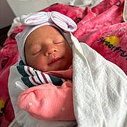 Kaelanie is registered to the contest to win money with this photo: newborn, baby, blanket, hat, sleeping, pink, white, wrapped, cute, infant, portrait, bed, soft, cozy, resting, child, hospital, clothing, headwear, peaceful