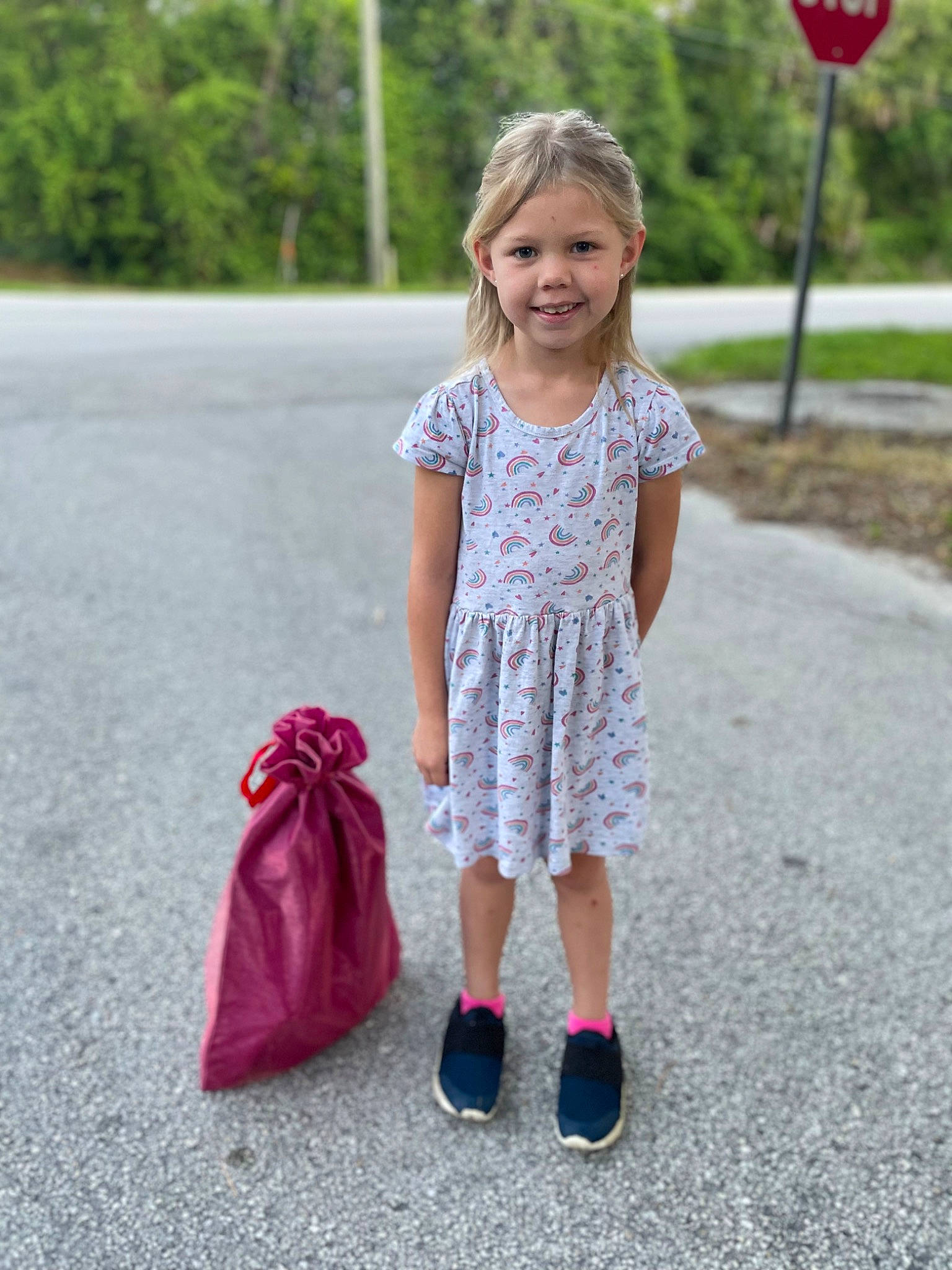 Madalynn is registered to the contest to win money with this photo: asphalt, baby_toddler_clothing, dress, facial_expression, fun, grass, hairstyle, happy, joy, people_in_nature, person, pink, plant, red, shoulder, sleeve, smile, standing, street_fashion, t_shirt