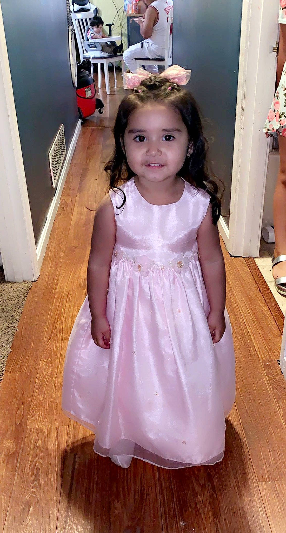 Stephanie is registered to the contest to win money with this photo: baby_toddler_clothing, bridal_accessory, day_dress, dress, embellishment, event, fashion_design, floor, flooring, formal_wear, gown, hair, happy, hardwood, head, joy, kitchen_appliance, long_hair, person, smile