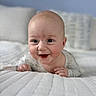 Jedidiah is registered to the contest to win money with this photo: baby, infant, smiling, drool, bed, white_bedding, face, skin, cute, happy, child, portrait, indoors, person, young, head, eyes, mouth, hands, lying_down
