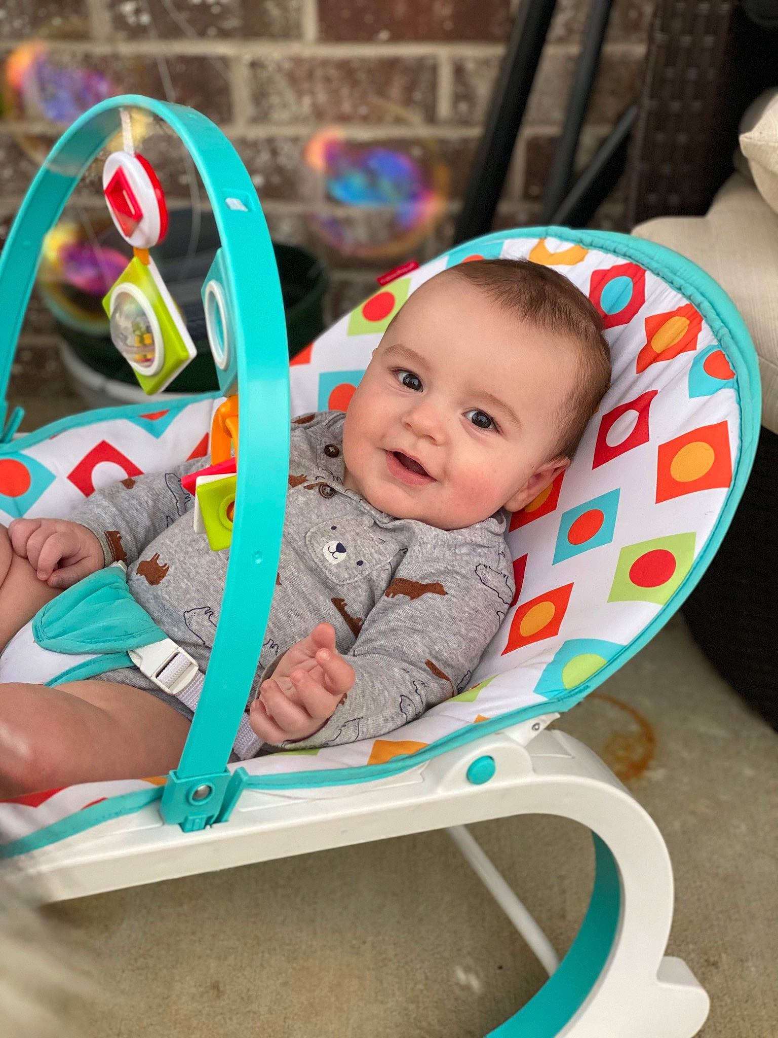 Myles is registered to the contest to win money with this photo: baby, baby_playing_with_toys, baby_products, baby_toddler_clothing, chair, child, comfort, facial_expression, fun, grass, happy, joy, leisure, person, play, recreation, room, sitting, smile, steering_wheel