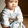 baby, child, crawling, stuffed_animal, toy, blue, white, striped_sweater, indoor, wooden_floor, soft_light, cute, curious, face, eyes, hands, clothing, young_child, person, portrait