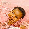 Zara is registered to the contest to win money with this photo: baby, child, infant, pink, sparkly, sequins, tulle, cute, portrait, face, hands, clothing, soft, background, adorable, lying_down, expression, closeup, person, baby_girl