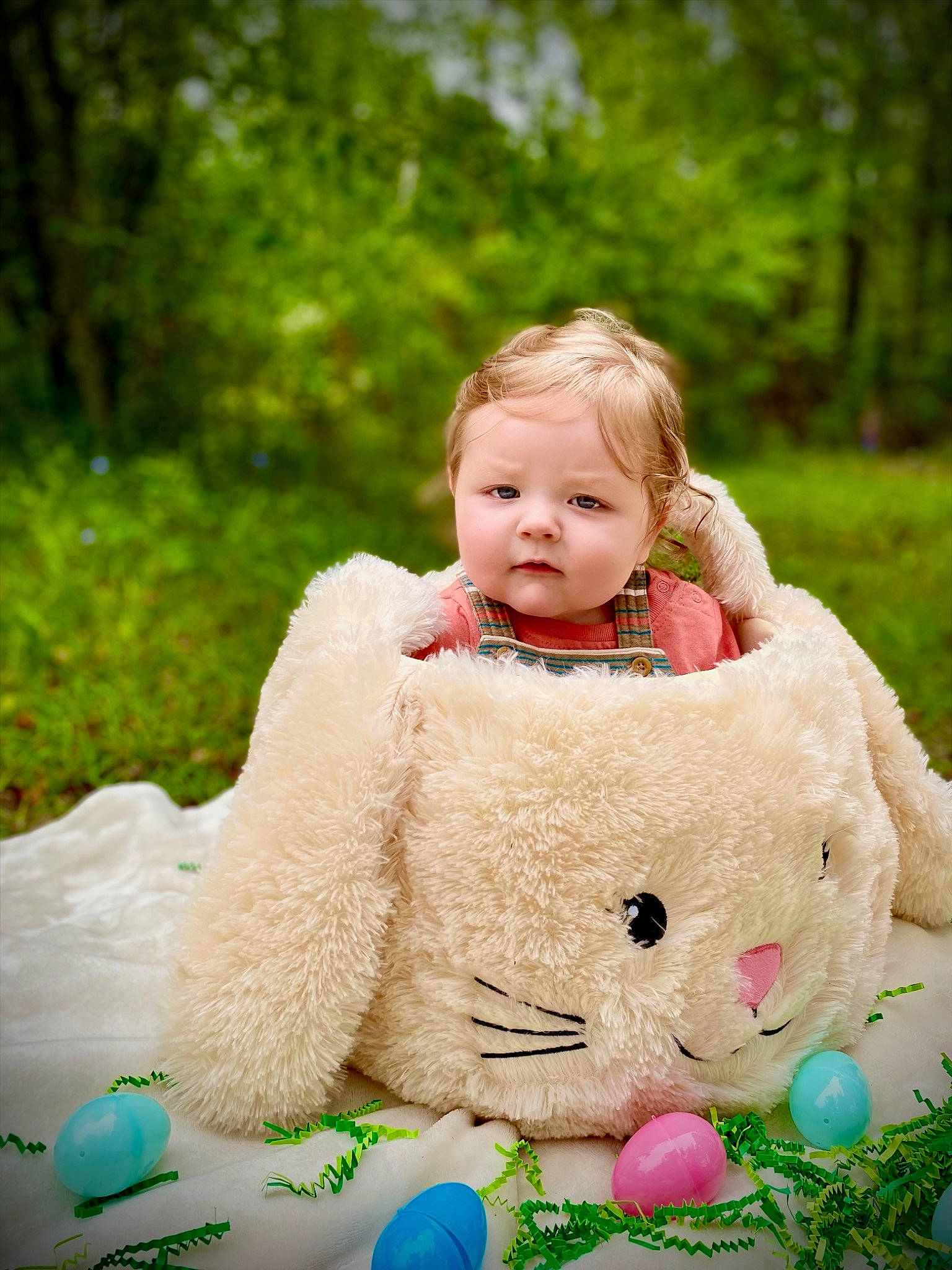 Rhett is registered to the contest to win money with this photo: baby, baby_toddler_clothing, child, dress, eye, face, fun, grass, green, happy, leisure, people_in_nature, person, pink, recreation, sitting, skin, toddler, toy, tree