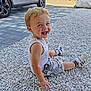 car, child, clouds, cute, daytime, grass, happy, nature, outdoor, pavement, person, shorts, sitting, sky, smiling, sneakers, stones, tank_top, toddler, young