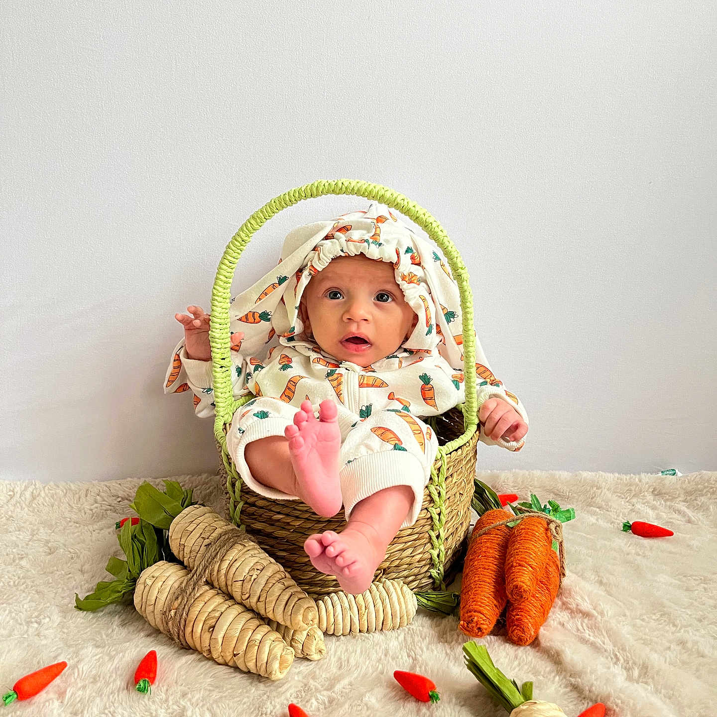 Xyleek joined the competition — help win amazing prizes! baby, basket, carpet, carrot, child, clothing, curious, cute, decor, face, foot, hand, indoor, infant, playful, plush_carrot, sitting, soft, white_wall, woven