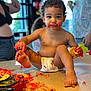 toddler, child, cake, messy, diaper, birthday, table, food, crumbs, frosting, indoor, celebration, party, hands, foot, face, people, background, curly_hair, smiling
