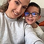 Tyler participe au concours pour gagner de l'argent avec cette photo : woman, child, smiling, glasses, selfie, indoor, casual_clothing, sofa, clock, happy, face, portrait, home, sitting, light_sweater, brown_hair, short_hair, eyewear, family, together