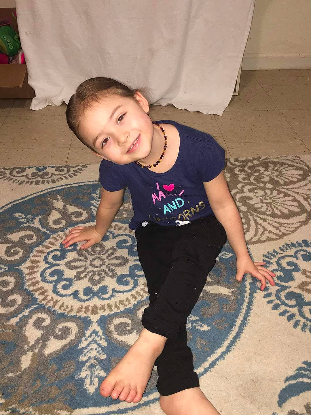 Gracelynn is registered to the contest to win money with this photo: arm, baby_toddler_clothing, finger, floor, flooring, hand, happy, head, human_body, iris, joint, joy, knee, leg, person, sleeve, smile, sportswear, t_shirt, thigh