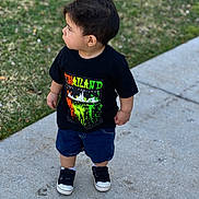 Nico is registered to the contest to win money with this photo: boy, casual_clothing, child, cute, daylight, feet, grass, hair, lawn, looking_away, outdoor, pavement, portrait, profile_view, shorts, sidewalk, sneakers, standing, toddler, tshirt