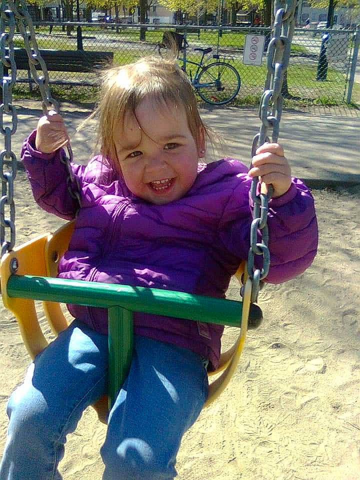 Abby-gaelle participe au concours pour gagner de l'argent avec cette photo : bicycle, bicycle_wheel, child, city, fun, grass, leisure, outdoor_play_equipment, person, photograph, plant, playground, purple, recreation, sitting, smile, swing, tire, toddler, tree