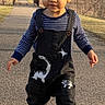 toddler, child, walking, outdoor, path, overalls, dinosaur, sneakers, park, trees, bridge, sunlight, smiling, person, nature, casual_clothing, daytime, cute, young_child, fashion
