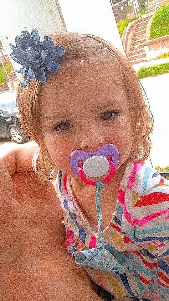 Izzy is registered to the contest to win money with this photo: baby, cheek, child, face, fun, head, mouth, neck, nose, person, play, skin, summer, toddler, vacation