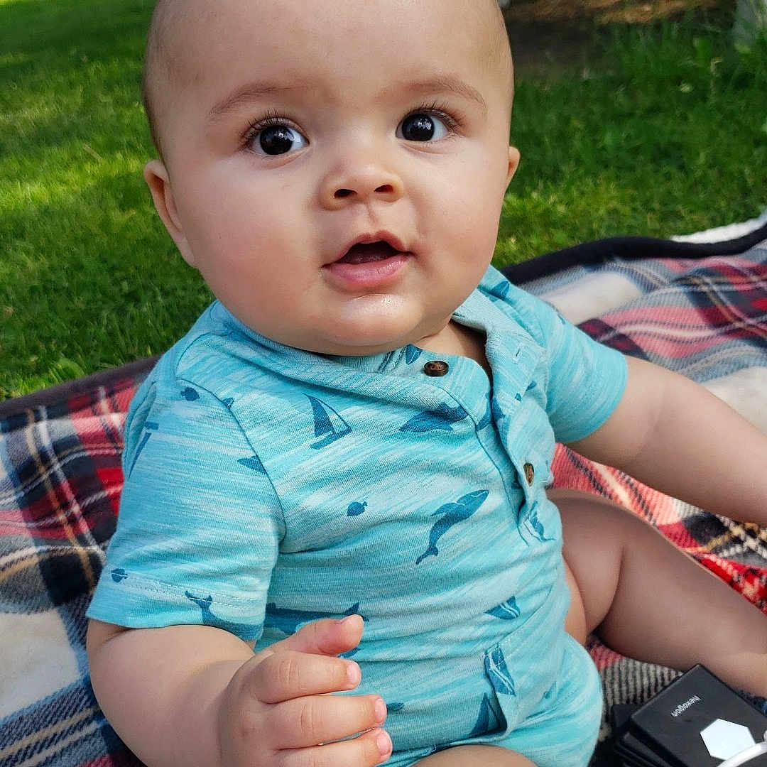 Poseidon is registered to the contest to win money with this photo: architecture, baby, backyard, building, clothing, face, grass, head, nature, outdoors, park, person, photography, plant, portrait, shelter, shorts, sitting, summer, yard