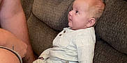 Aria joined the competition — help win amazing prizes! baby, child, man, couch, sofa, indoor, smile, face, clothing, blanket, interaction, person, home, seated, looking, cozy, fabric, furniture, cute, affection