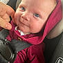 baby, infant, child, face, blue_eyes, hoodie, maroon_clothing, car_seat, seatbelt, hand, finger, close_up, cute, adorable, smile, skin, child_seat, safety, indoor, portrait