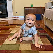 Weston joined the competition — help win amazing prizes! baby, carpet, casual_clothing, child, couch, cute, fireplace, floor, furniture, happy, home_interior, indoors, infant, living_room, person, rug, sitting, smiling, toddler, wood_floor