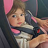 toddler, child, car_seat, pink, seatbelt, sweater, portrait, baby, cute, indoors, sitting, clothing, person, face, hair, hand, safety, travel, car, seat