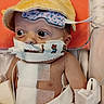 baby, infant, medical_equipment, hospital, bandages, tubes, yellow_cap, face, eyes, teddy_bear_tape, hospital_bed, healthcare, child, person, cute, newborn, patient, closeup, indoors, vulnerable