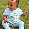 toddler, child, grass, outdoor, blue_clothing, bow, curly_hair, jewelry, bracelet, necklace, earring, sitting, leggings, butterfly_pattern, serious_expression, baby, nature, cute, portrait, daylight