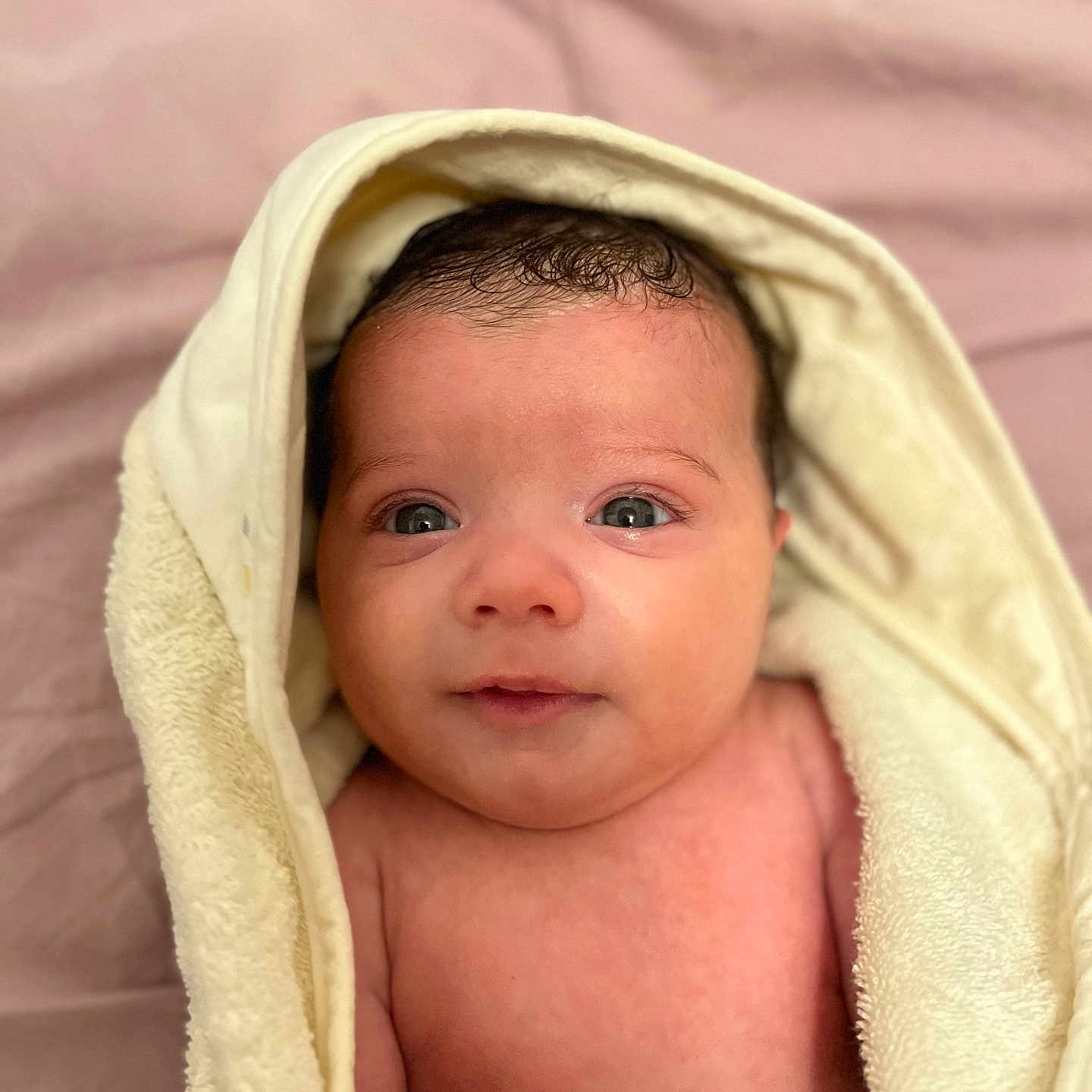 Celine is registered to the contest to win money with this photo: baby, bathtowel, bed, blanket, bonnet, clothing, face, furniture, happy, hat, head, hood, hoodie, newborn, person, photography, portrait, quilt, smile, towel