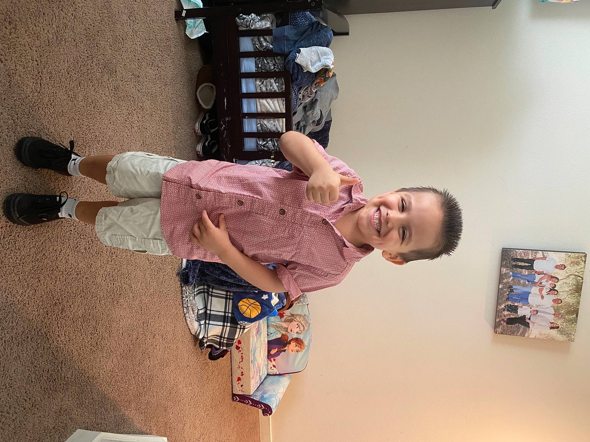 Eddie is registered to the contest to win money with this photo: child, elbow, flooring, fun, happy, human_leg, joy, knee, machine, pattern, person, picture_frame, room, smile, sock, street_fashion, t_shirt, thigh, toddler, visual_arts