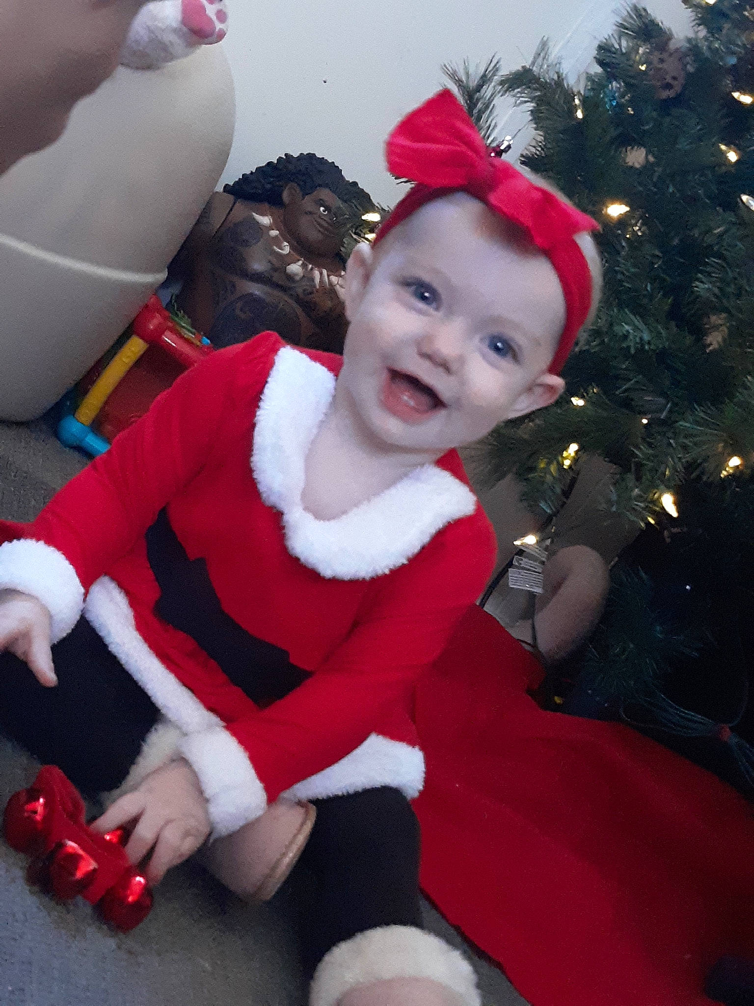 Laela is registered to the contest to win money with this photo: chair, child, christmas, christmas_tree, costume, costume_hat, event, fictional_character, fun, happy, hat, holiday, human_body, joy, lap, person, red, santa_claus, smile, thigh