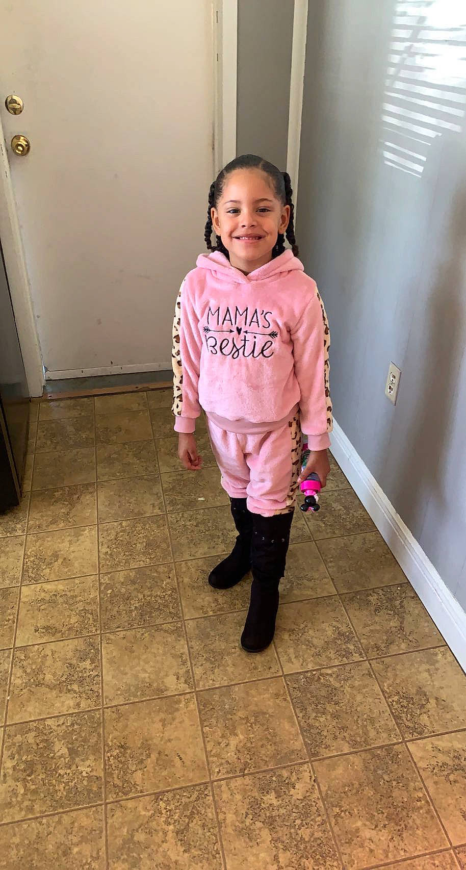 Dorothy is registered to the contest to win money with this photo: baby_toddler_clothing, blond, child, denim, door, fashion_design, floor, flooring, fun, happy, human_leg, joy, knee, magenta, person, shoulder, sleeve, smile, t_shirt, thigh