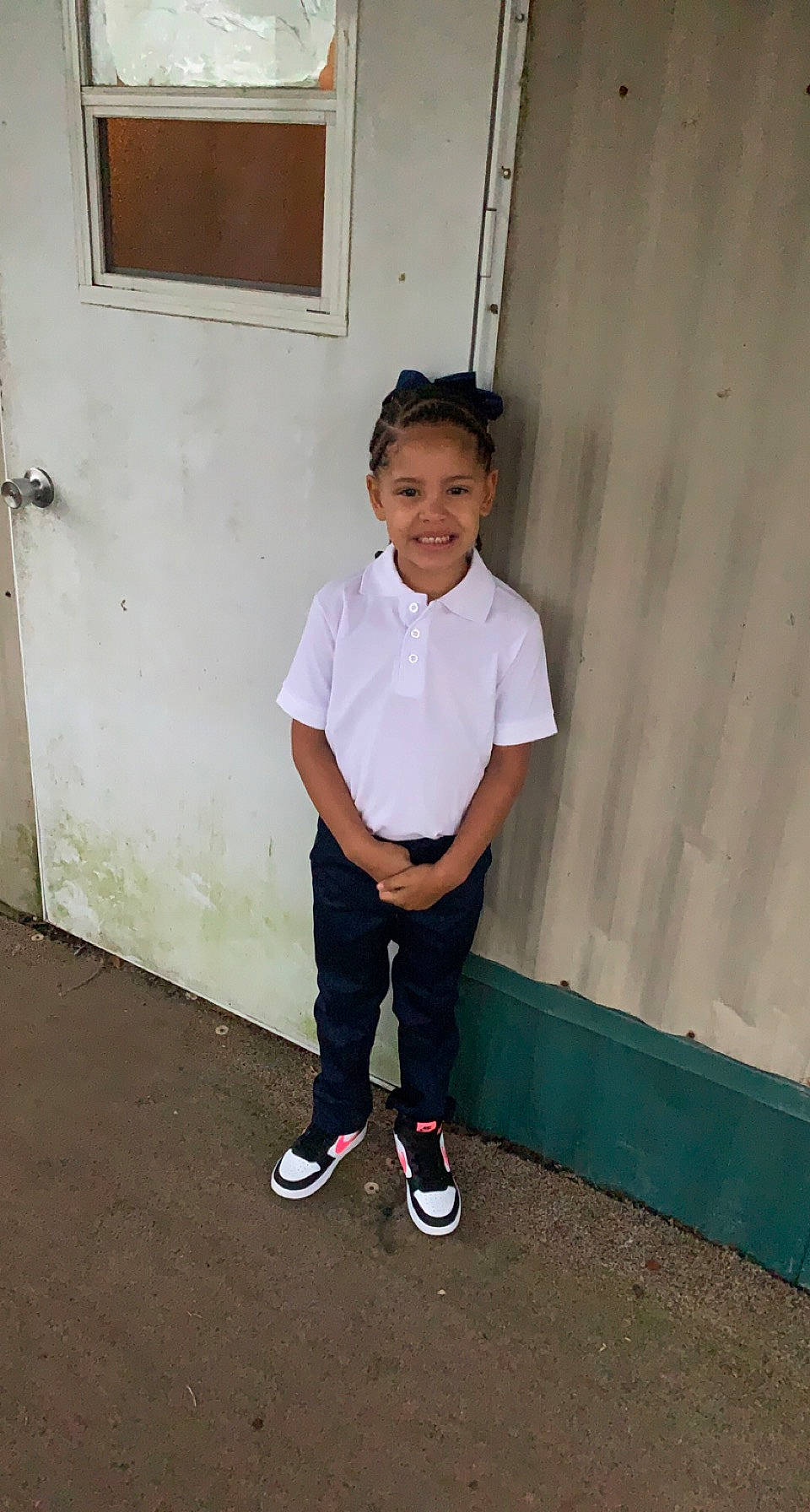 Dorothy is registered to the contest to win money with this photo: child, chin, door, electric_blue, eyewear, fun, happy, hat, human_leg, joy, knee, pattern, person, room, sleeve, smile, sneakers, sportswear, t_shirt, thigh