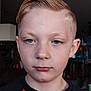 Colten is registered to the contest to win money with this photo: child, boy, portrait, face, blue_eyes, blonde_hair, short_hair, indoor, casual_clothing, red_shirt, black_shirt, young, person, serious_expression, head_and_shoulders, closeup, human, skin, eyebrows, lips