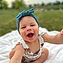 Evelina joined the competition — help win amazing prizes! baby, child, smiling, happy, headband, onesie, outdoor, grass, blanket, cute, infant, portrait, sitting, reaching, playful, young_child, natural_light, close_up, face, skin
