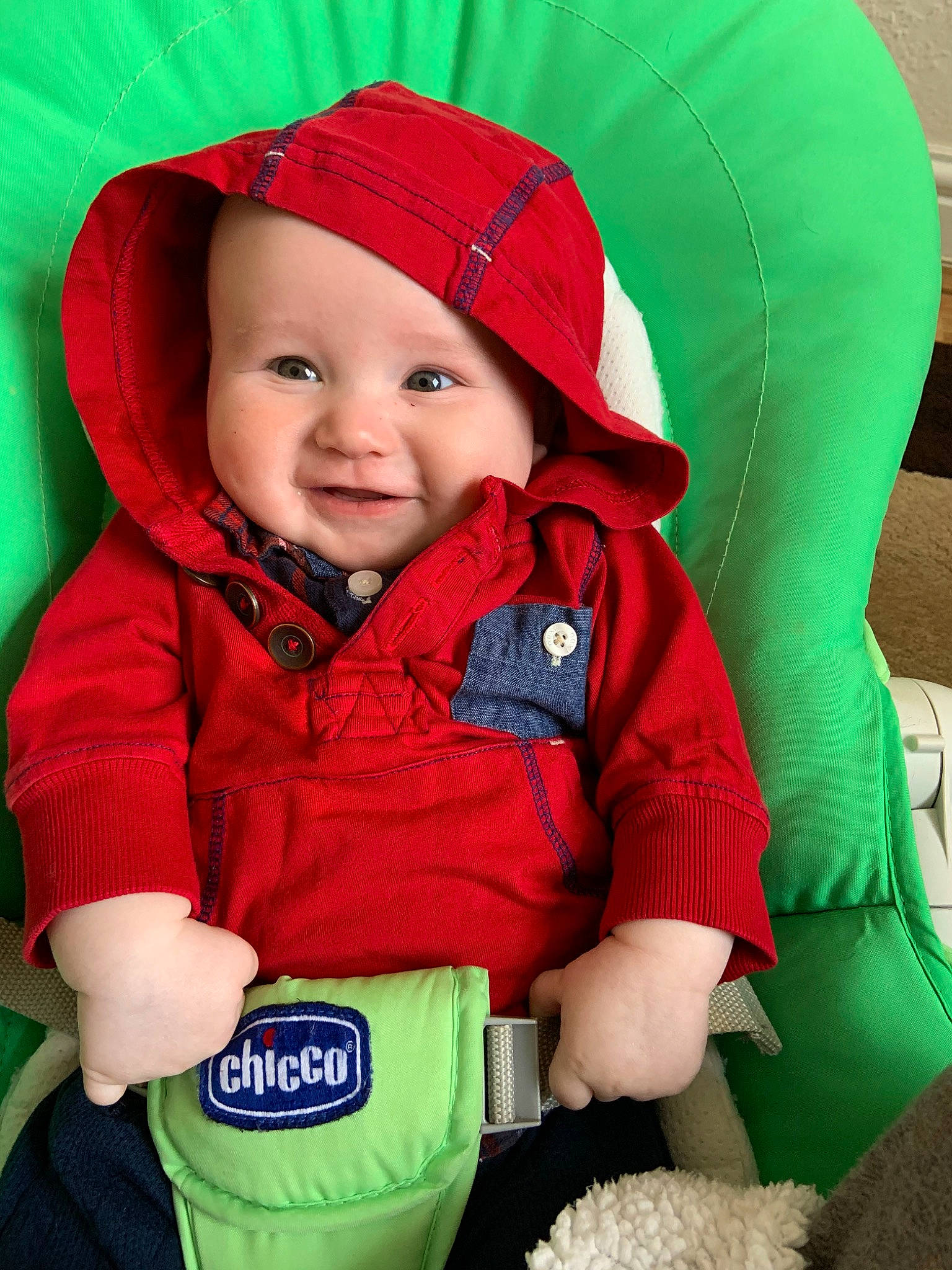 Jenson joined the competition — help win amazing prizes! baby, baby_carriage, baby_products, child, fictional_character, green, headwear, hood, hoodie, jacket, outerwear, person, product, red, skin, sleeve, smile, toddler