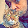 Savanah participe au concours pour gagner de l'argent avec cette photo : person, cat, tabby_cat, face, eyes, hoodie, close_up, pet, animal, indoor, affection, fur, whiskers, portrait, companionship, curious, alert, candid, cute, cozy