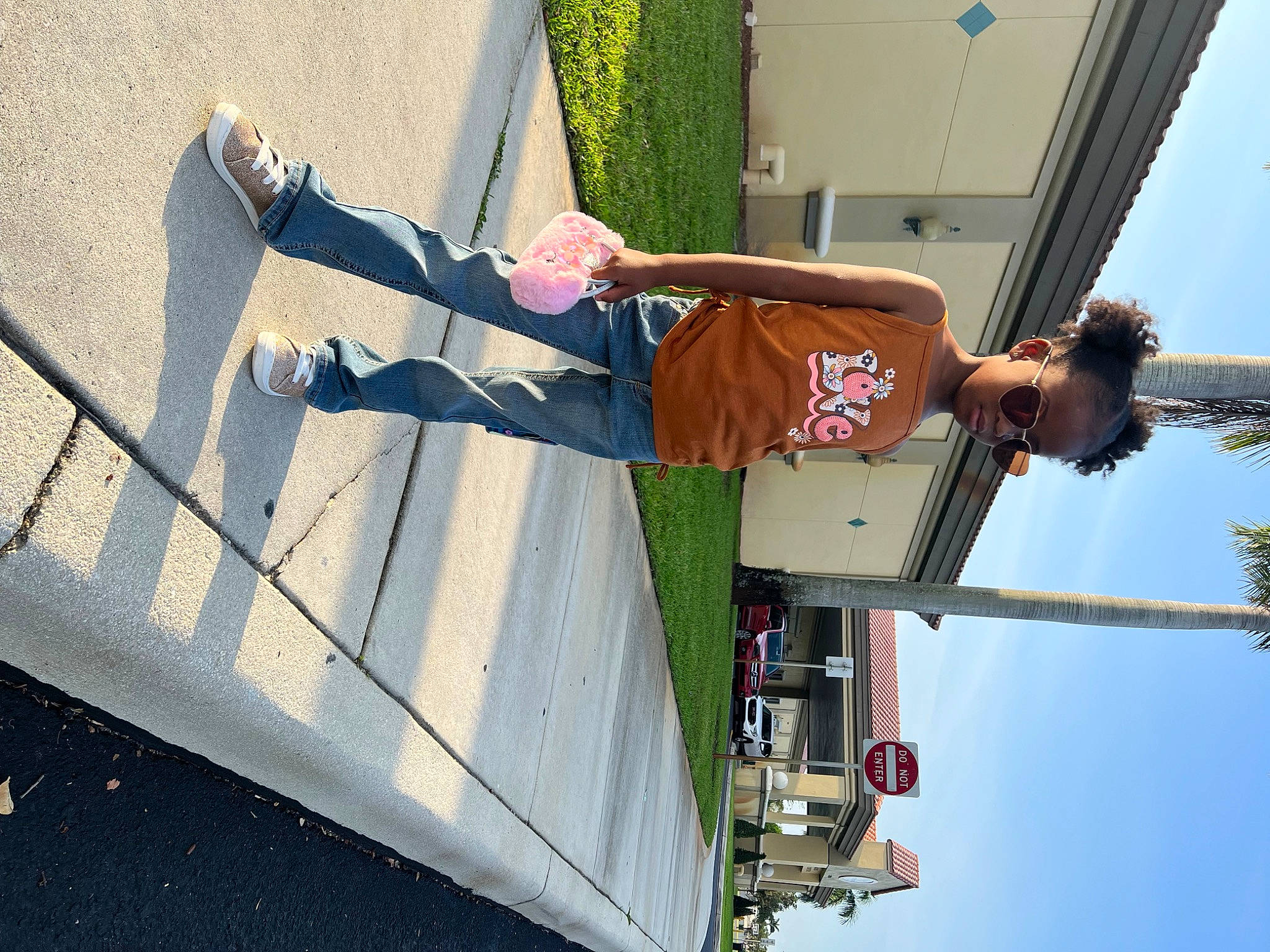 Nevaeh is registered to the contest to win money with this photo: asphalt, elbow, fun, human_leg, leisure, line, outdoor_shoe, pedestrian, person, plant, recreation, road_surface, shadow, sky, smile, travel, walking_shoe