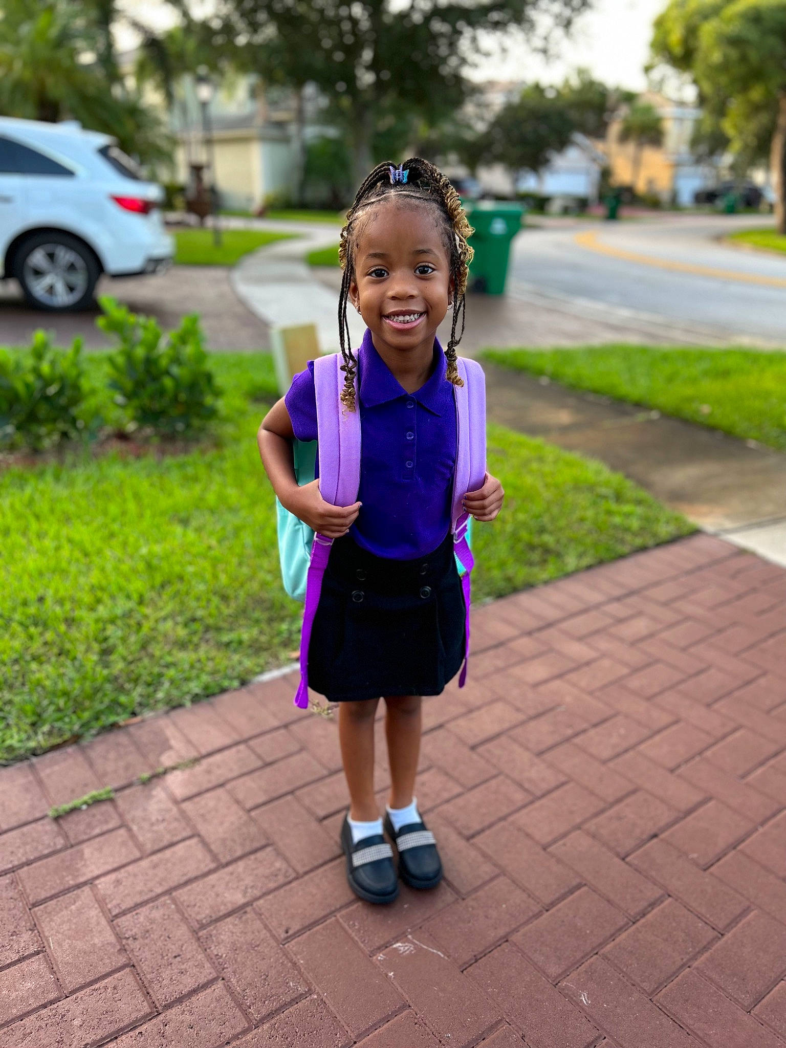Nevaeh is registered to the contest to win money with this photo: arm, baby_toddler_clothing, car, dress, electric_blue, grass, hair, happy, joy, leaf, leisure, person, pink, plant, public_space, recreation, sidewalk, smile, tire, toddler