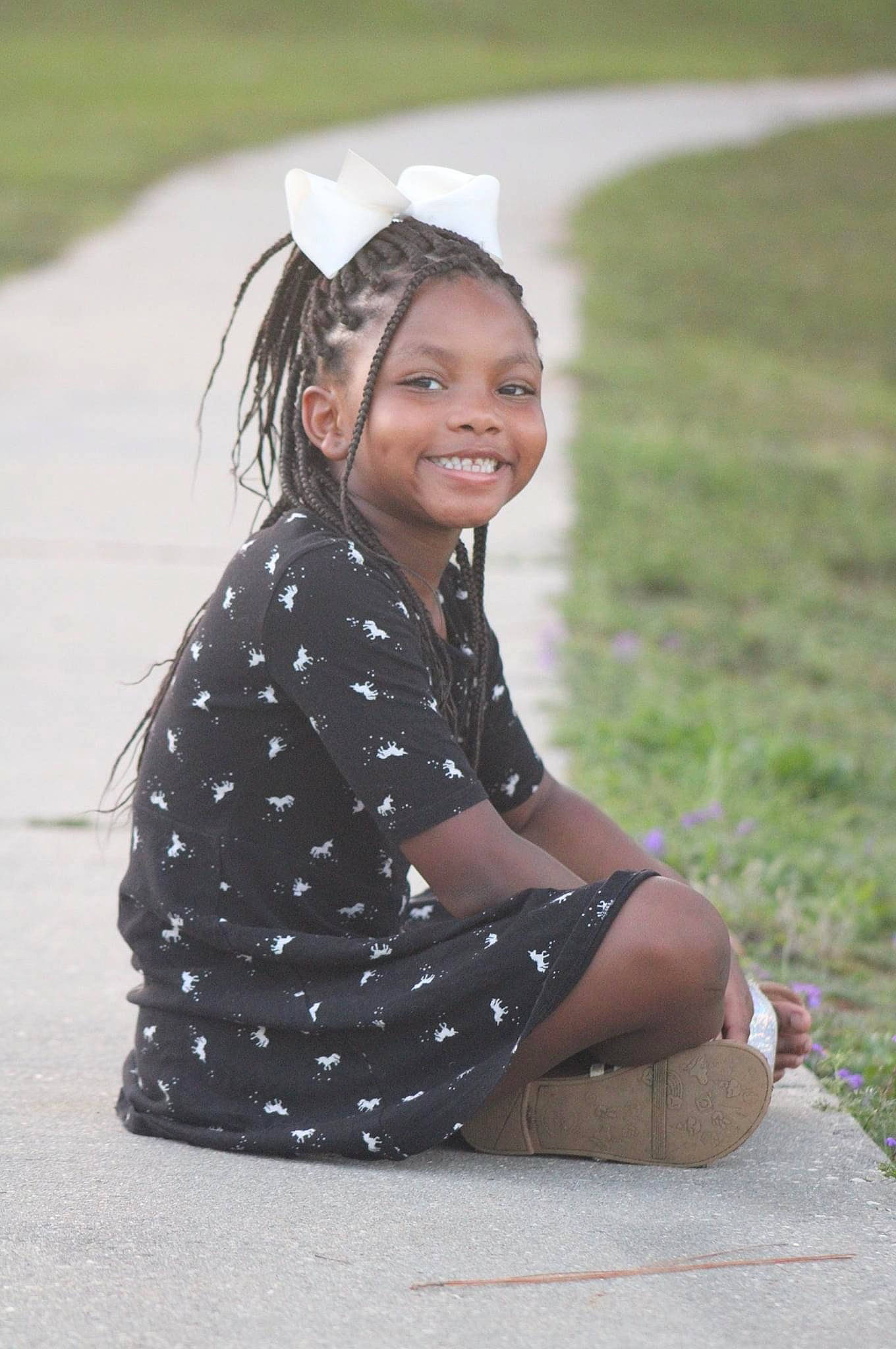 Dayana joined the competition — help win amazing prizes! child, design, dress, facial_expression, fun, grass, hair_accessory, happy, head, headband, joy, outerwear, pattern, person, photography, polka_dot, sitting, skin, smile, summer