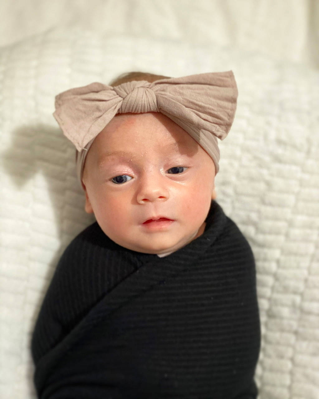 Samantha is registered to the contest to win money with this photo: baby, bonnet, cheek, child, costume_accessory, ear, eye, face, fashion_accessory, hat, head, headgear, headwear, organ, person, skin, toddler, wool