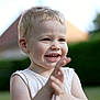 child, toddler, smiling, clapping, outdoor, daylight, happy, blond_hair, face, person, nature, greenery, shirt, sleeveless, portrait, young_child, expression, cute, playful, skin