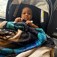 Prince joined the competition — help win amazing prizes! baby, blanket, car_seat, child, indoors, window, snow, winter, curious, person, face, hands, cozy, warm, clothing, portrait, infant, seat, young_child, cute