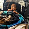 baby, blanket, car_seat, child, indoors, window, snow, winter, curious, person, face, hands, cozy, warm, clothing, portrait, infant, seat, young_child, cute
